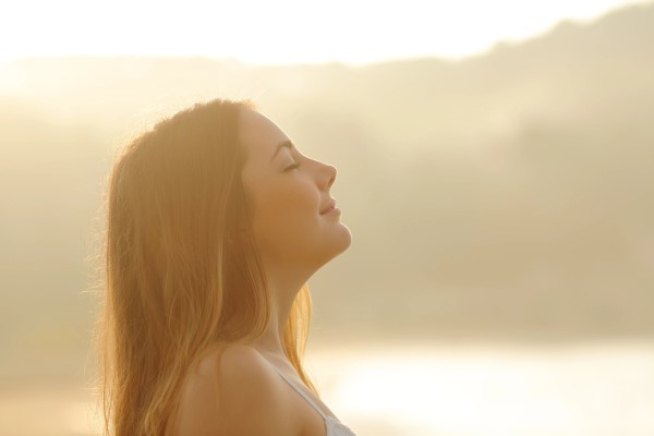 A woman breathing in the fresh air around her