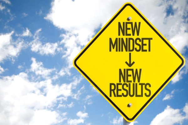 Road sign reading "New Mindset, New Results"