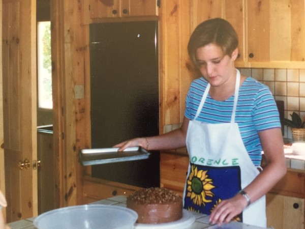 Charlotte Kikel pictured in her younger years, making her first cake to sell