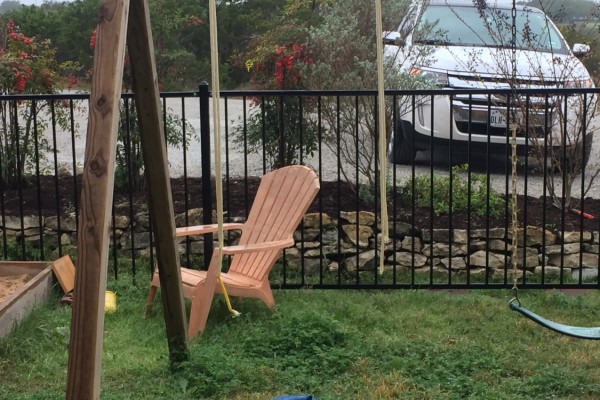 Wooden chair outside by a swing set on a gloomy day