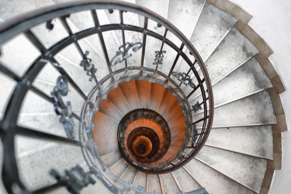 Looking down a long, winding spiral staircase